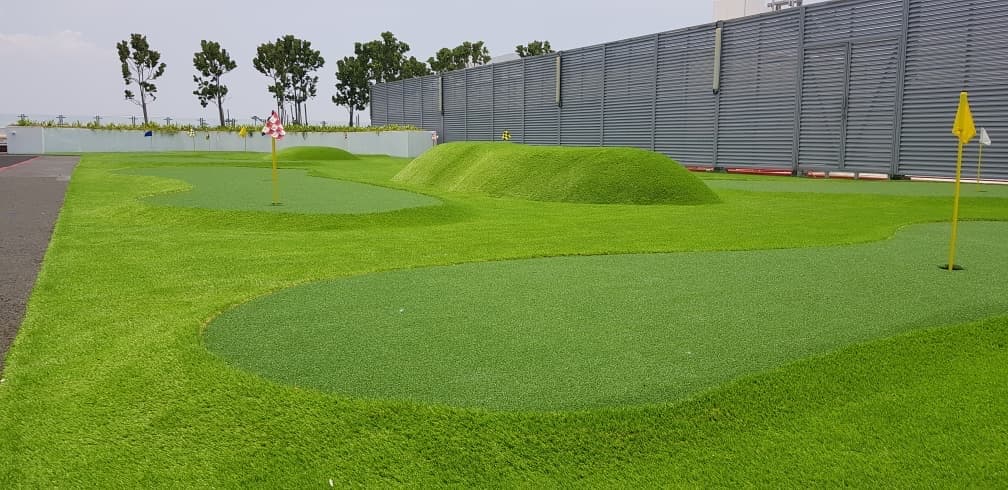 Artificial putting green installation at Air Asia Red Q in Sepang, view 1